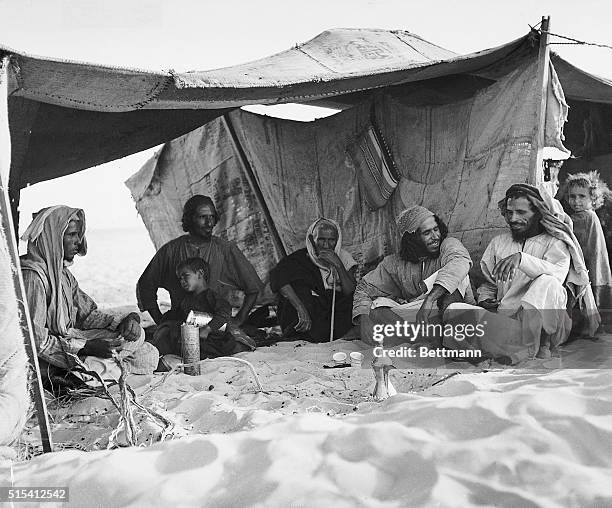Abqaiq, Al Hasa, Saudi Arabia-: A Bedouin man entertaining friends in his tent in the desert near Abqaiq. This Arab , is a watchman employed by...