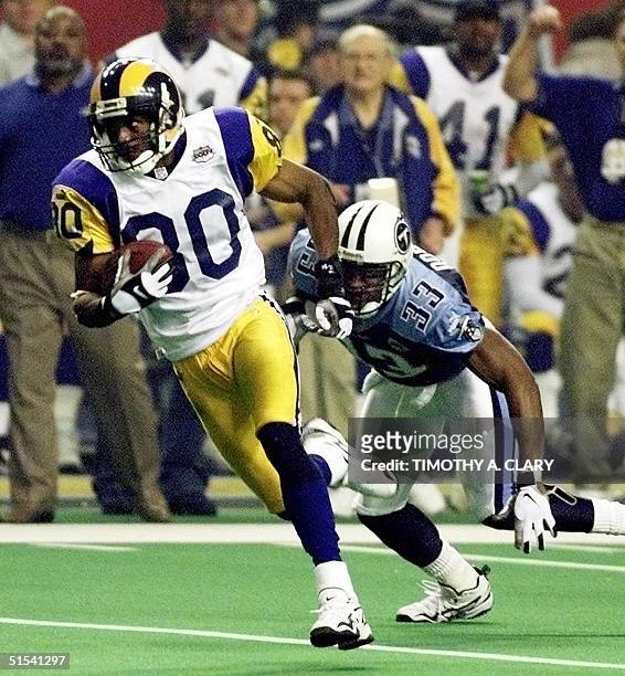 St. Louis Rams wide receiver Isaac Bruce runs for what proves to be the winning touchdown after catching a Kurt Warner pass late in the second half...