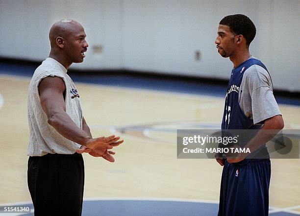 Washington Wizard basketball co-owner Michael Jordan gives instruction to Wizard Richard Hamilton during a round of practice at the MCI Center 31...