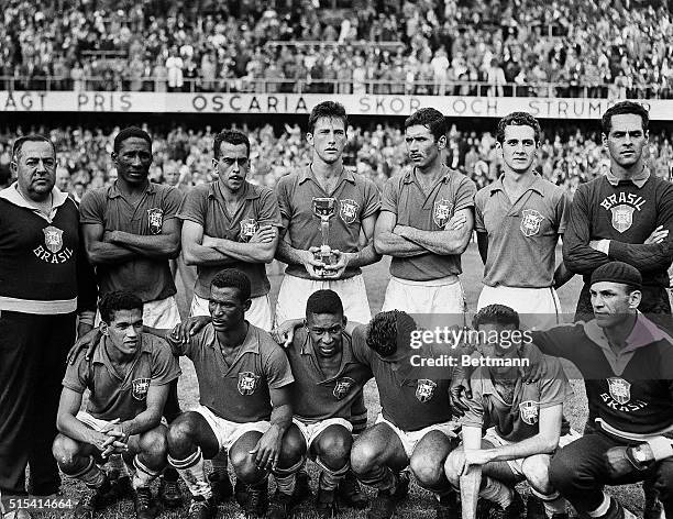 Stockholm, Sweden-: Members of Brazil's soccer team pose together after defeating Sweden to win the world soccer championship here, 6/29. It was the...