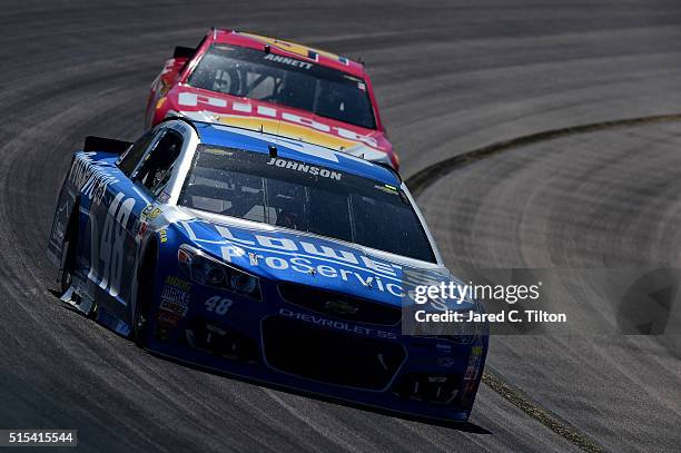 Jimmie Johnson, driver of the Lowe's Pro Services Chevrolet, leads Michael Annett, driver of the Pilot Flying J Chevrolet, during the NASCAR Sprint...