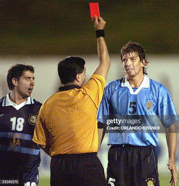 Mariano Messera of the Argentinian soccer team observed the referee, Byron Moreno expel Gabriel Garcia of Uruguay from the game 04 February, 2000 in...