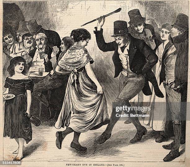 New Year's Eve in Ireland. A man and a woman dancing with a crowd of people in the background. Undated engraving.