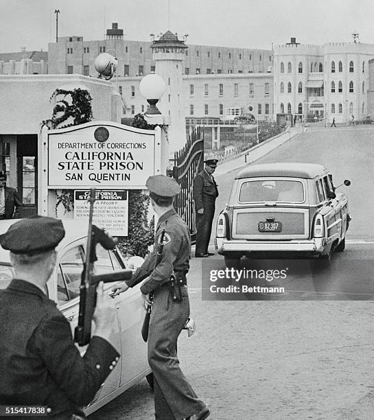 Los Angeles County Sheriff's van passes through gates of San Quentin Prison, bearing convicted killers, Jack Santo and Emmett Perkins, closer to...