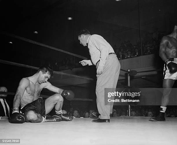 Referee Teddy Martin counts over Angelo Defendis who was floored in the fifth round by White Plains middleweight Rory Calhoun. Defendis was saved by...