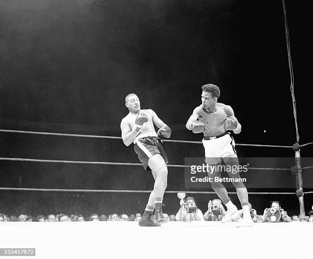 Big Bob Baker leans back to evade the hurricane of blows from Tommy "Hurricane" Jackson in the third round of their heavyweight go at the Garden...