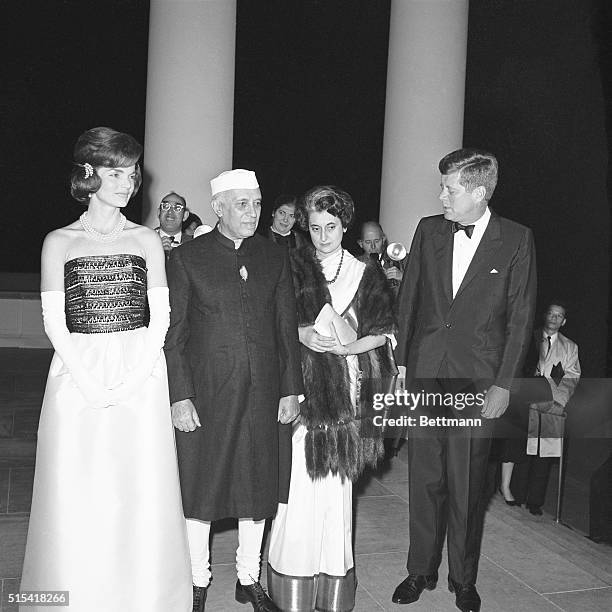 President Kennedy and the First Lady greet Indian Prime Minister Nehru as he arrives at the White House tonight for a small private black tie dinner...