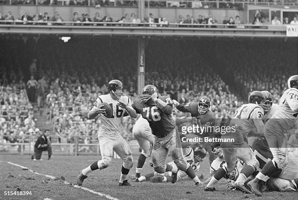 Norm Snead, , Washington Redskins is back here, to pass, but is unsuccessful in getting it off as Rosey Grier, , of the New York Giants breaks thru...