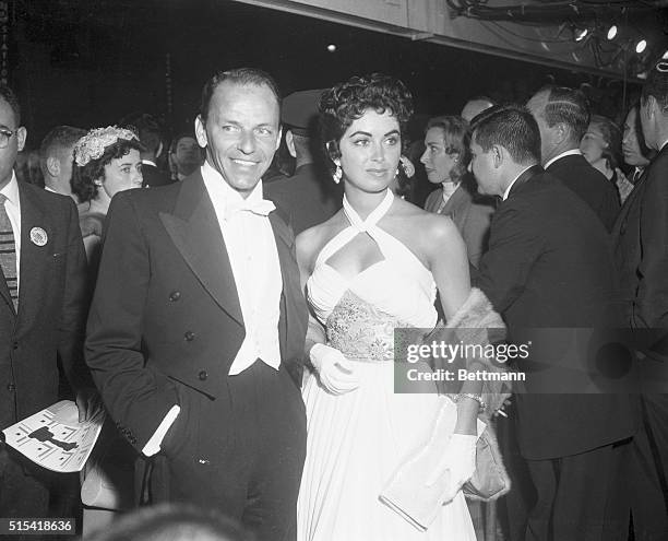 Actor Frank Sinatra and model actress Peggy Connolly are shown arriving at the Pantages Theater in Hollywood for the 28th annual Academy Awards...