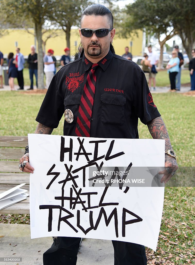 trump-supporter-brian-werner-holds-a-sign-prior-to-a-rally-for-republican-presidential.jpg