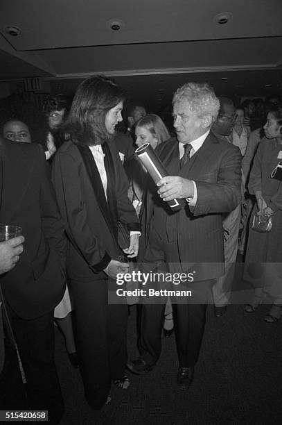 New York, NY- Jacqueline Kennedy Onassis, who has served a stint as an editor with a book publishing company, chats with author Norman Mailer at a...