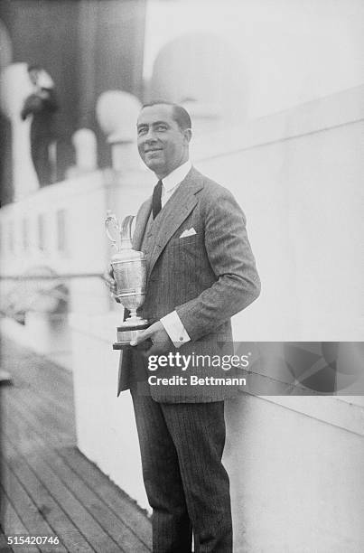 Golf Champions: Walter Hagen with his Cup as he arrived here today from abroad.