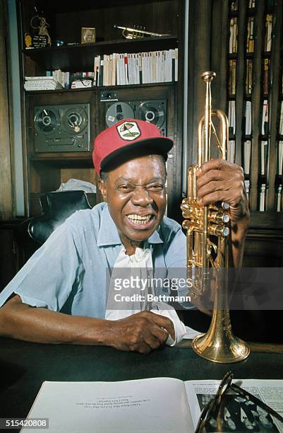 Corona, NY: World renowned jazz trumpeter Louis "Satchmo" Armstrong, who celebrated his 70th birthday July 4, 1970 displays his famous trumpet in the...