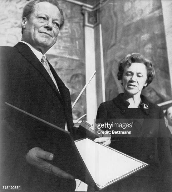 West German Chancellor Willy Brandt receives the 1971 Nobel Peace Prize from Mrs. Aase Lionaws, Chairman of the Nobel Committee of the Norwegian...