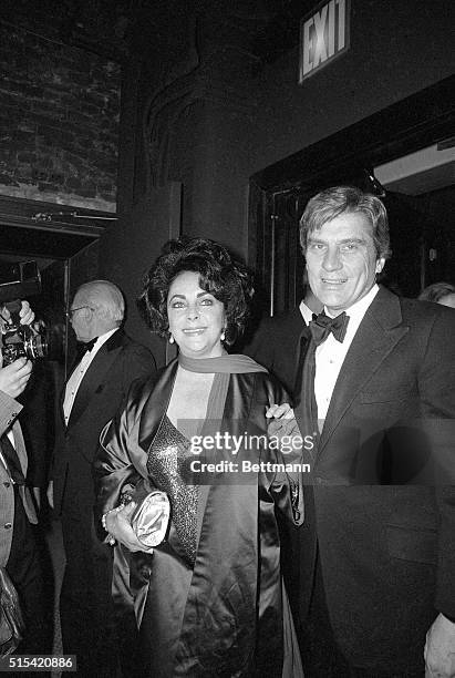 New York, New York- Picture shows actres, Elizabeth Taylor, and husband, John Warner, holding hands.