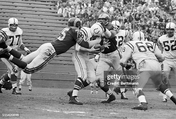 First quarter action in the Ram-Colts Game shows Colt Quarterback, Johnny Unitas, as he was thrown for a loss behind his own scrimmage line by Dave...