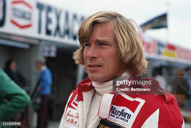 Portrait of racecar driver James Hunt in pits.