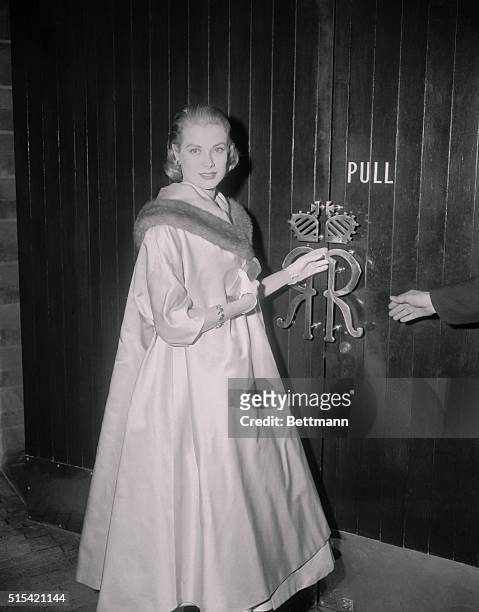 Morgan Higgins, of MGM Studios, is shown escorting Grace Kelly up the steps of Romanoff's where she was guest of honor at a party given her by...