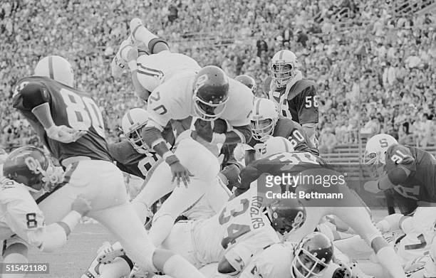 Stanford University, California: Oklahoma's Billy Sims , goes up and over the Stanford line to score Oklahoma's first TD in the first quarter of...