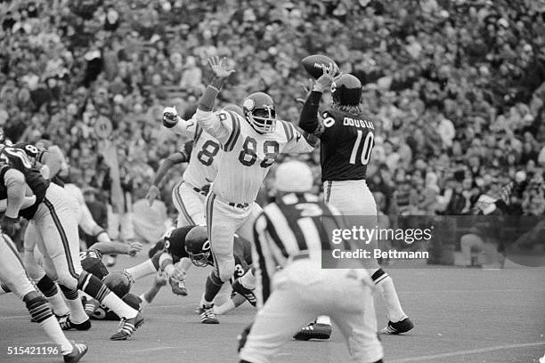 Minnesota Vikings defensive tackle Alan Page, "surrounds" Chicago Bear's quarterback Bobby Douglass during the Vikings-Bears game at Chicago here....