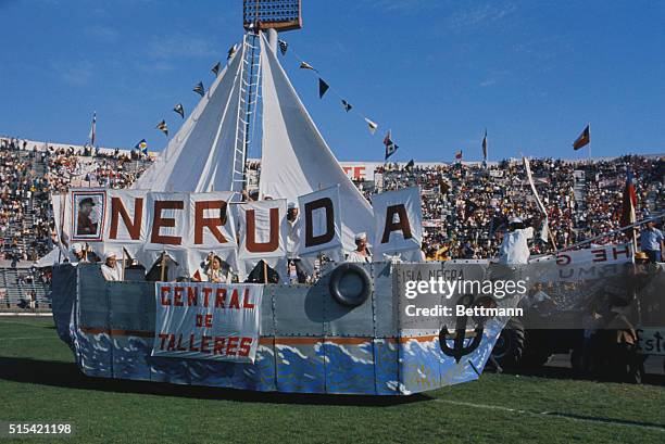 Santiago, Chile: Sign on float in Santiago's National Stadium indicates pride in Pablo Neruda, Chile's Ambassador to France who was awarded this...