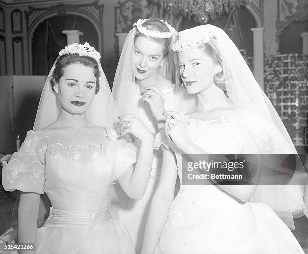 Models Harlene Pops, left, Ellen Wood, center, and Joan Priestley, played the role of brides today at a unique all-bridal fashion show at the Hotel...