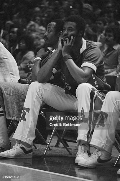 Philadelphia 76er teammates Joe Bryant and George McGinnis sit on the bench and watch their team lose to the Washington Bullets in Game 4 of the 1978...