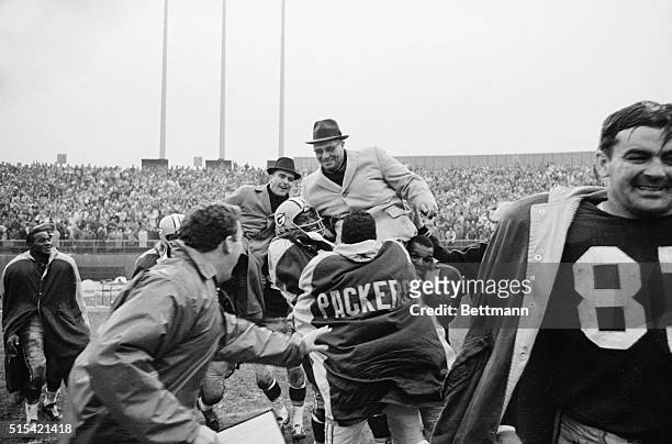 Green Bay Packers Coach Vince Lombardi is hauled up on the shoulders of his players and carried of the field, after the Packers defeated the New York...