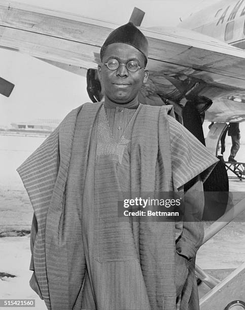 Chief Obafeni Awolowo, premier of the western region of Nigeria boards an American Airlines flagship to Washington at Idlewild Airport. The chief is...