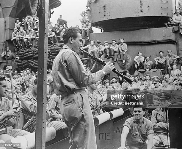 Little persuasion is needed to call Navy men on deck when Artie Shaw gives use of the clarinet. Now a band leader in the Navy, Shaw relieves the...