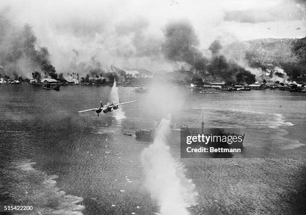 Rabaul, New Guinea: Clean Sweep at Rabaul. With the shore a flaming inferno, American planes continue their mission of destruction in Rabaul Harbour,...