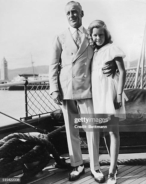 Edward F. Hutton, prominent society type and sportsman, photographed here with his daughter, Nedenia, on the deck of his yacht, Hussar, in Honolulu...