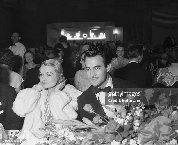 Constance Collier and Gilbert Roland were photographed together at the recent President's birthday ball in the Warner Studio here. Some 2200 of the...