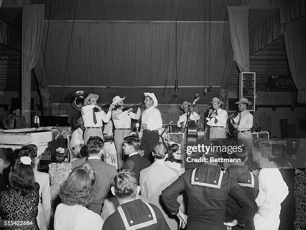 Oceanpark, California: Bob Wills' Cowboy Band playing at the Aragon Ballroom, Oceanpark, California. Left to right, at mike, Joe Ferguson, Bob Wills,...