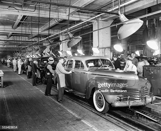 At the Chrysler Motor Co., cars go down the final inspection line.