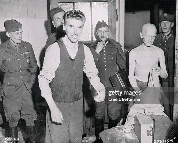 His bones stripped of every ounce of flesh, this man, who has spent the last five years in a Nazi prison camp at Dossel, Germany, exchanges his...