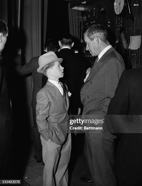 The dapper young man about town on the left is Mickey Rooney, now playing Puck in Midsummer Night's Dream, and Will Rogers talking backstage at the...