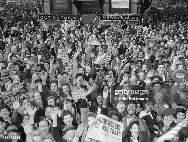 New York citizens are shown waving flags, as crowds gather in Times Square in a celebration for the surrender of German forces in Europe.