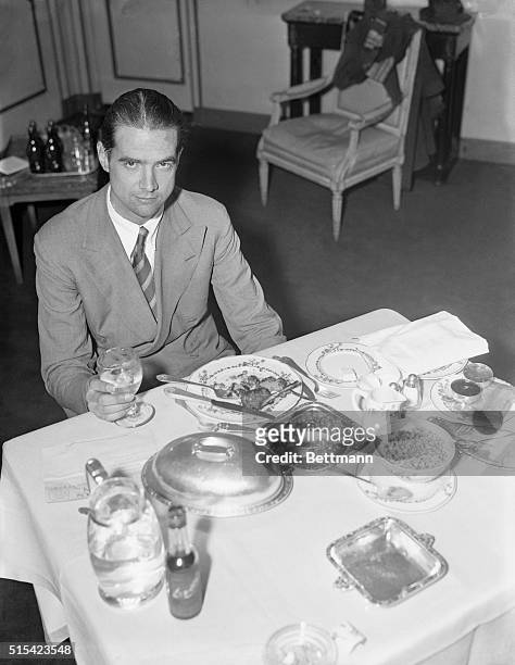Howard Hughes enjoys a hearty breakfast in his room at the Waldorf Astoria after flying across the continent from Los Angeles to Newark in the record...