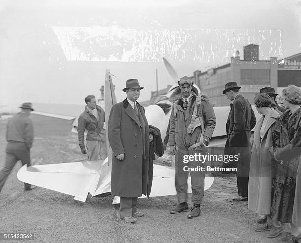 Howard Hughes, sportsman pilot and movie producer who averaged 332 miles an hour to set a new transcontinental air record is shown being welcomed at...