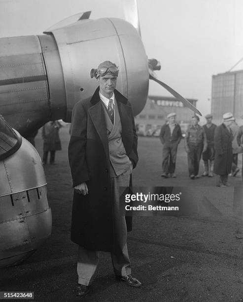 Scene at Newark Airport as crowd of spectators swarm about the plane of Howard Hughes, millionaire motion picture producer, after Hughes has...