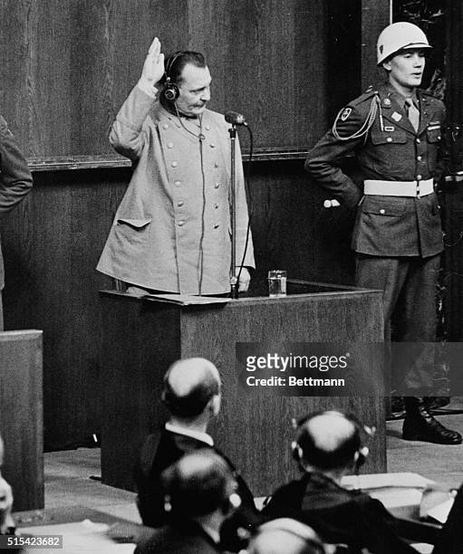 Goering Takes Oath at Nuremberg Trial. Nuremberg, Germany: His right hand raised, Hermann Goering, former Chief Marshal of Nazi Reich, takes oath...