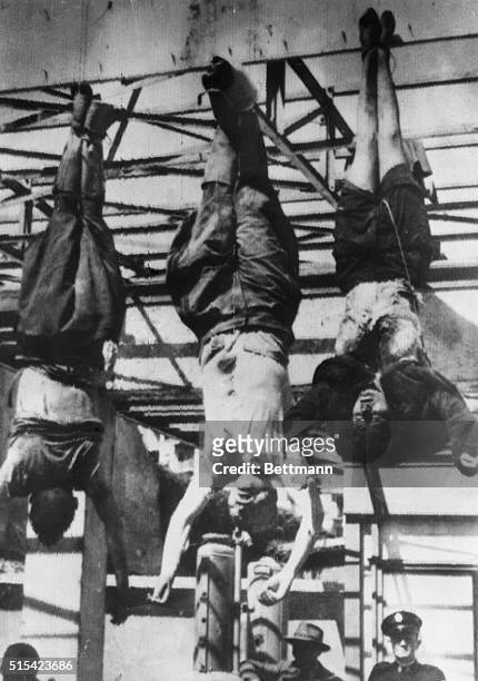 Benito Mussolini, his 33-year-old mistress, Claretta Petacci , and Lt. Gen. Achille Starace , secretary of fascist party, hang from their heels on...