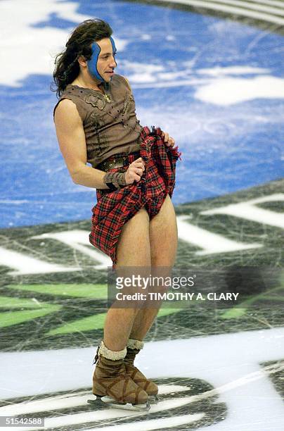 Philippe Candeloro of France, lifts his kilt to the judges during his performance of William West of Braveheart during the Artistic Men's performance...
