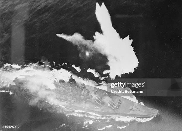 The Japanese battleship Yamato 000 ton warship, flees from bombs and torpedoes of attacking U.S. Pacific Fleet carrier planes. Fires can be seen amid...