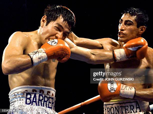 Super Bantamweight Champion Erik Morales of Tijuana, Mexico, lands a right to the head of WBO Super Welterweight Champion Marco Antonio Barrera, of...