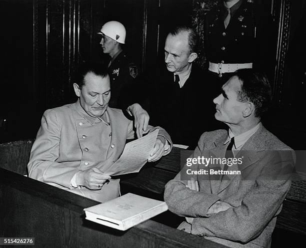 Herman Goering , Karl Doenitz and Rudolf Hess, once top Nazi leaders, get together during a lull in the war crimes trial.