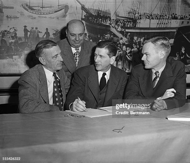 Gus Dorais, Detroit Lions coach, Arthur Sampson, Boston Yanks business manager, former commissioner Elmer Layden, and Wellington Mara, co-owner of...