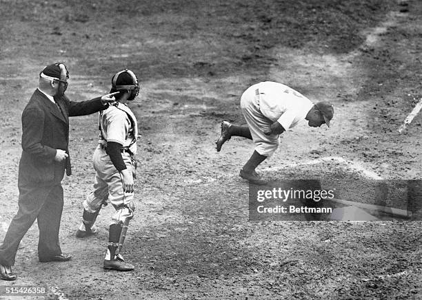 Umpire George Magerkurth motions Jackie Robinson to first base after the Dodgers first baseman was hit on the left arm by a pitched ball from Hank...