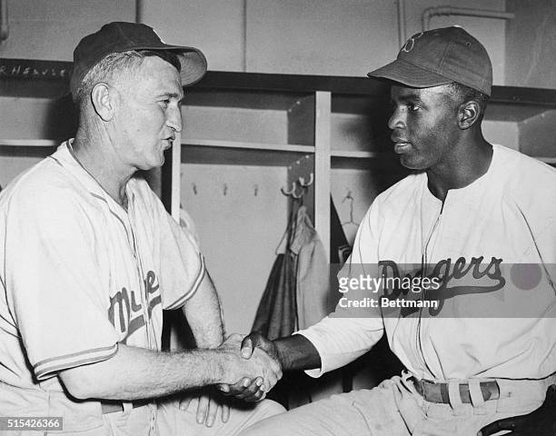 Jackie Robinson , first Negro to make a Major League, bids goodbye to Clay Hopper, manager of Montreal, Dodger farm team, as he leaves the club April...